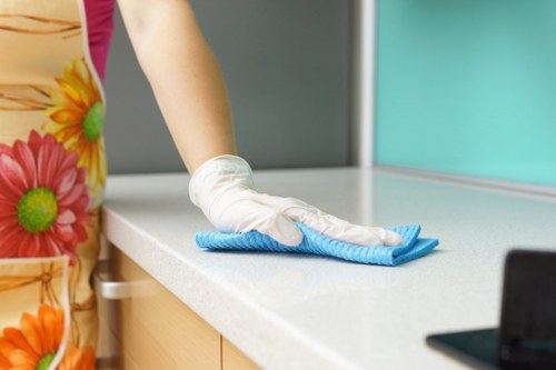 Cleaner using PPE while carrying out a safe cleaning task