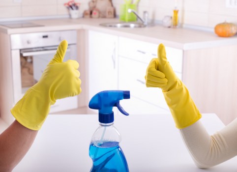 Cleaner using proper lifting technique with cleaning supplies