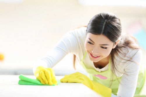 Team member following cleaning safety procedures in a professional environment